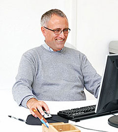 older man on a computer